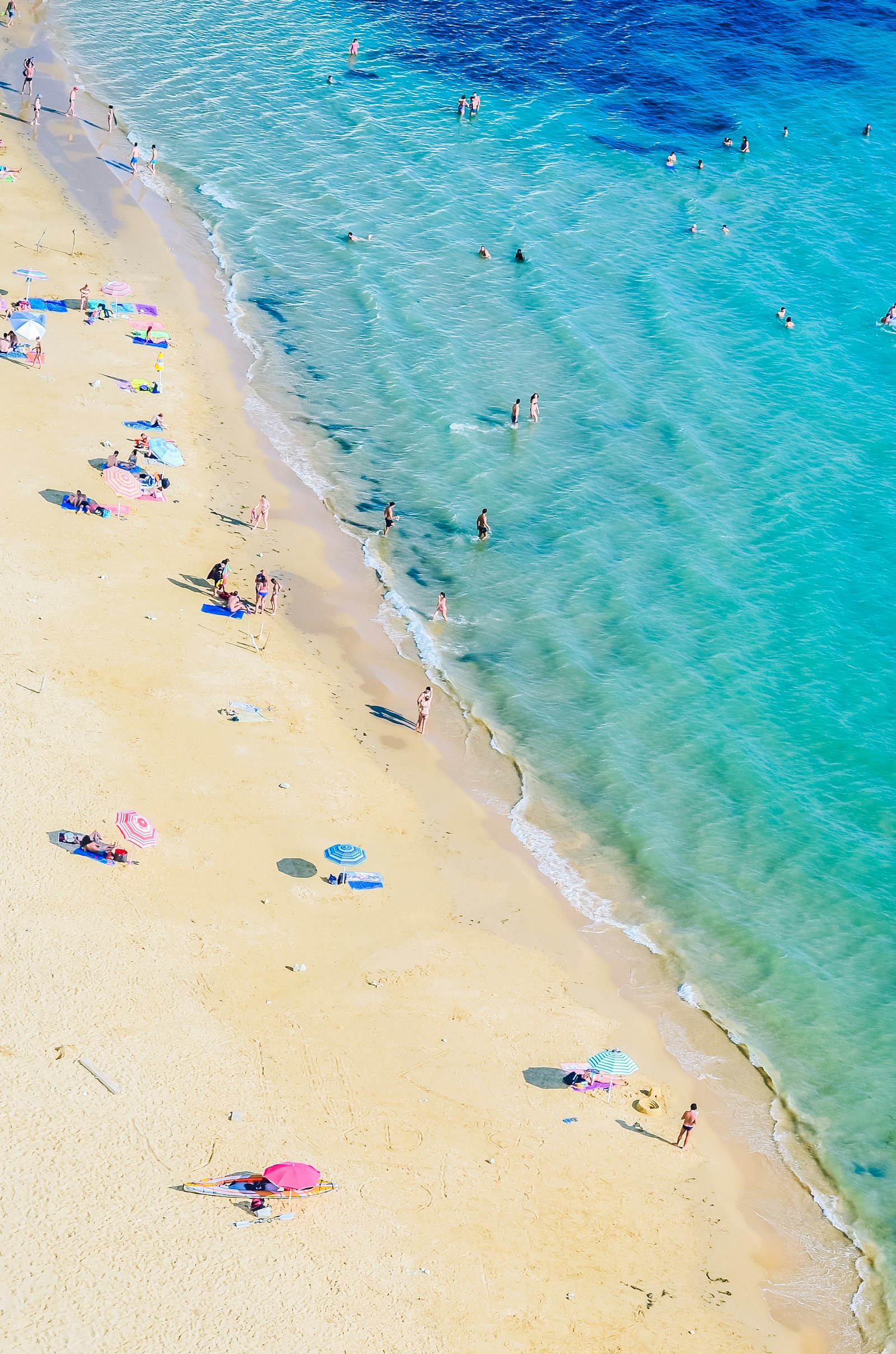 Aerial view of a sunny beach and turquoise water